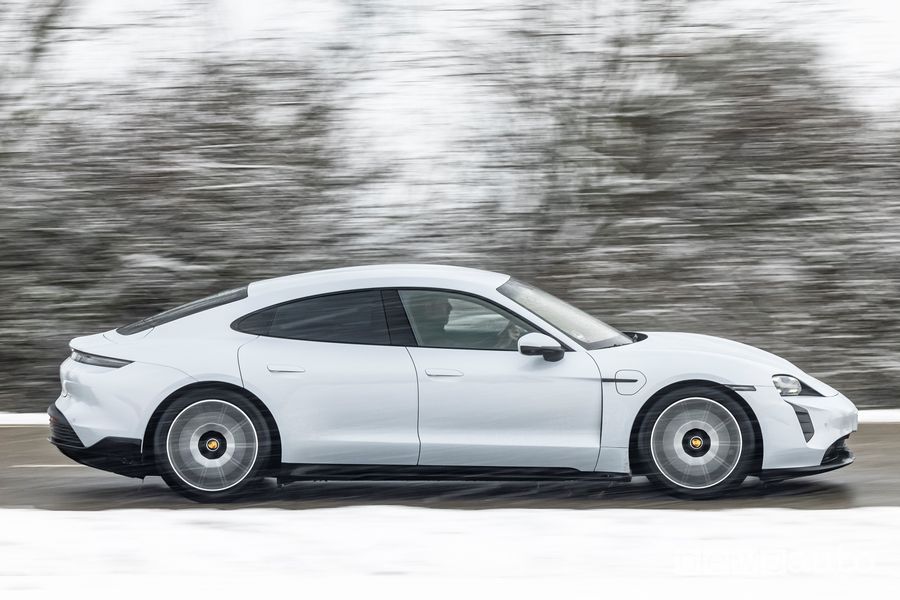Vista laterale Porsche Taycan elettrica bianca su strada