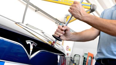 Tirabolli in azione mentre ripara danni da grandine su una Tesla